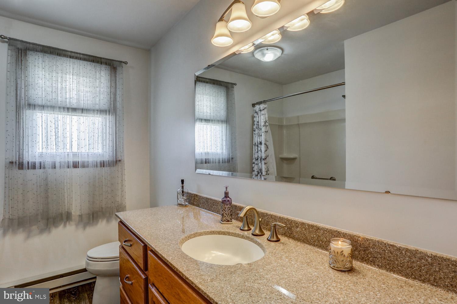 31 Trail Road South Elizabethtown, PA 17022 - Photo 17 of 40 a bathroom with a granite countertop sink a mirror and a toilet