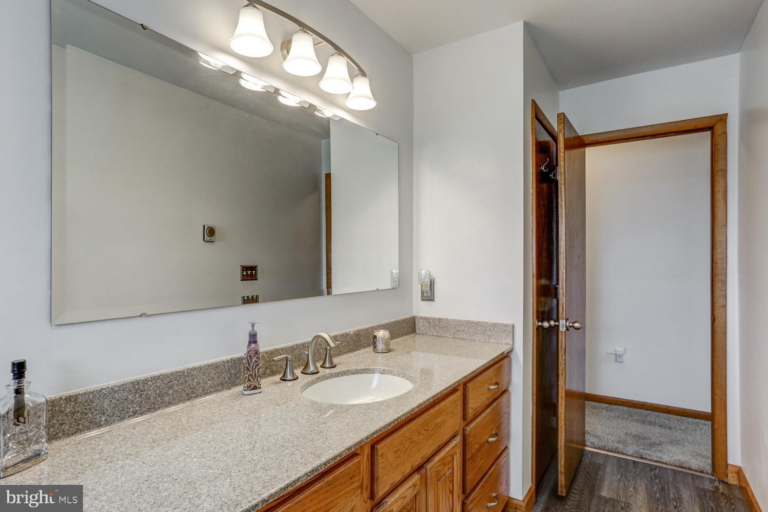 31 Trail Road South Elizabethtown, PA 17022 - Photo 18 of 40 a bathroom with a granite countertop sink and a mirror