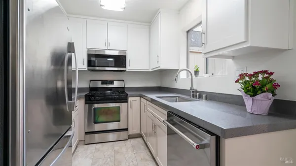 a kitchen with a sink and large window