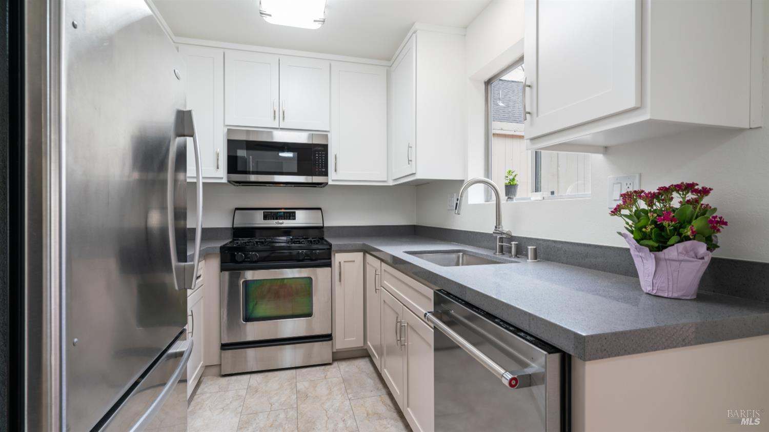 3335 Yulupa Avenue Santa Rosa, CA 95405 - Photo 12 of 39 a kitchen with stainless steel appliances granite countertop a sink a stove and a refrigerator
