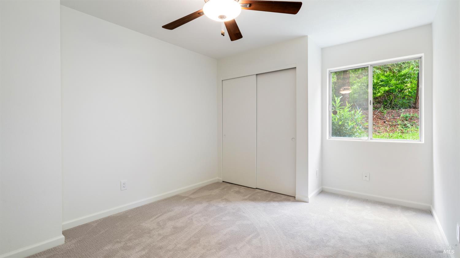 3335 Yulupa Avenue Santa Rosa, CA 95405 - Photo 17 of 33 The second downstairs bedroom offers new carpet, fresh paint, and a light-filled, welcoming atmosphere.