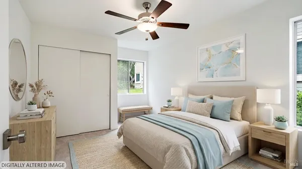 an empty room with closet and a ceiling fan