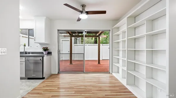 a kitchen with granite countertop a refrigerator and a stove top oven