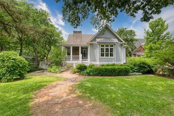 a house with a big yard and large trees