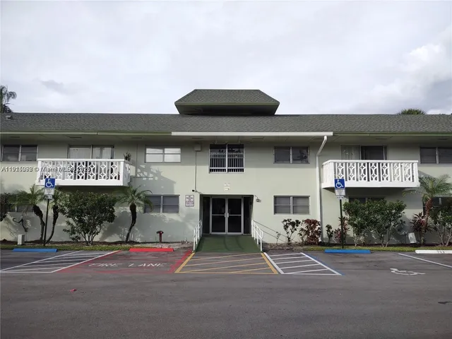 a front view of a building with parking