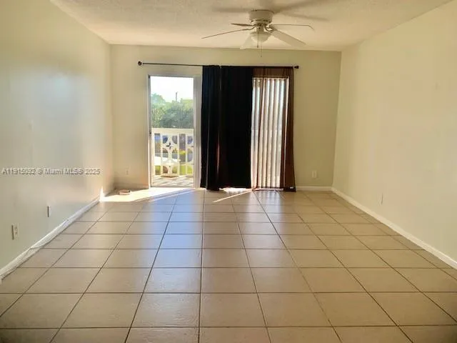 a view of a livingroom with an empty space and a window