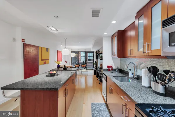 a kitchen with sink a stove and cabinets