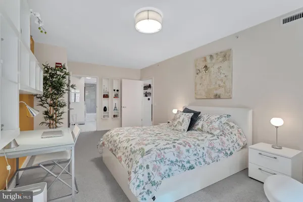 a bedroom with a large bed and a window