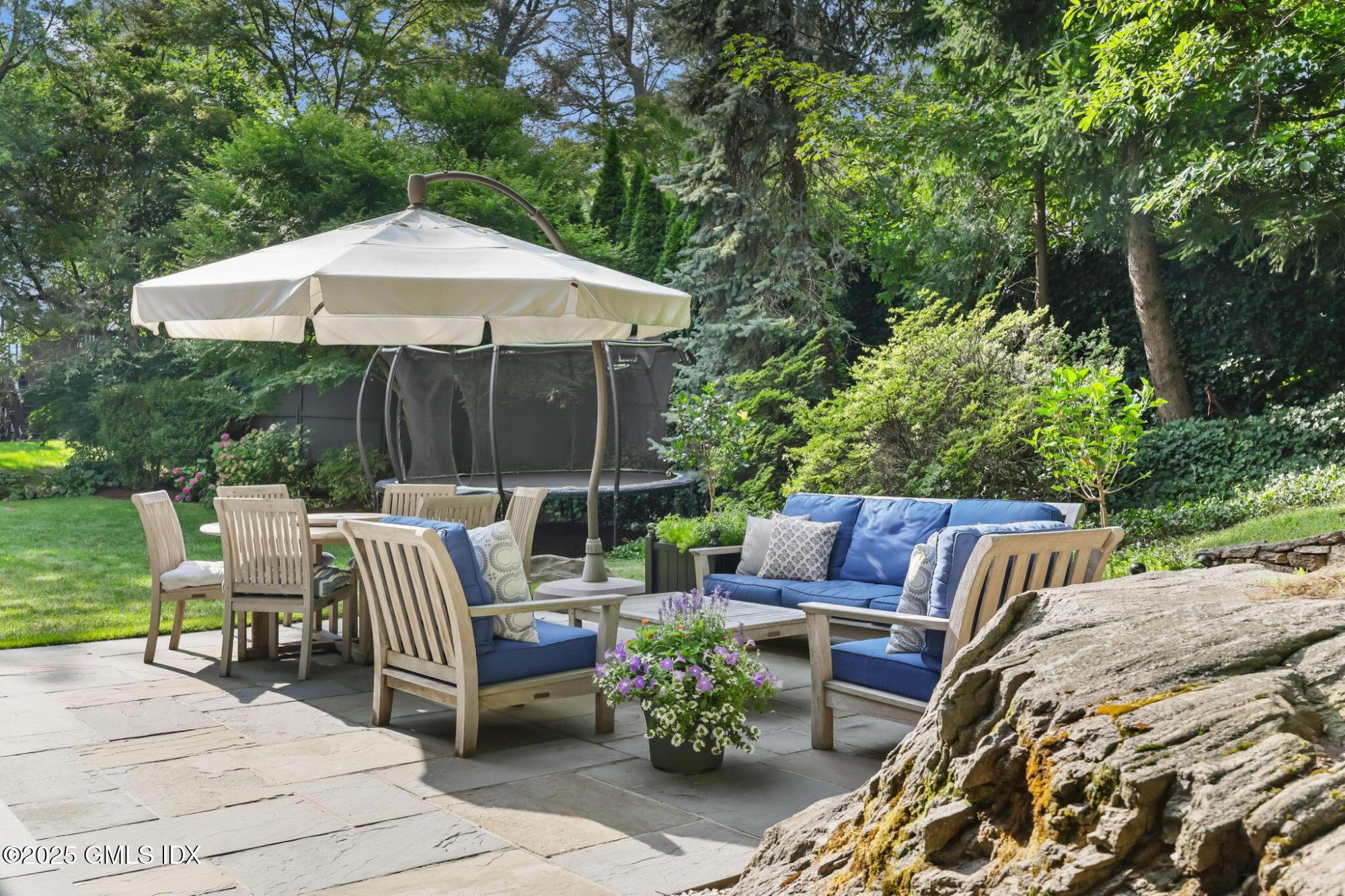 119 Hendrie Avenue Riverside, CT 06878 - Photo 5 of 7 a view of backyard with seating space and trees