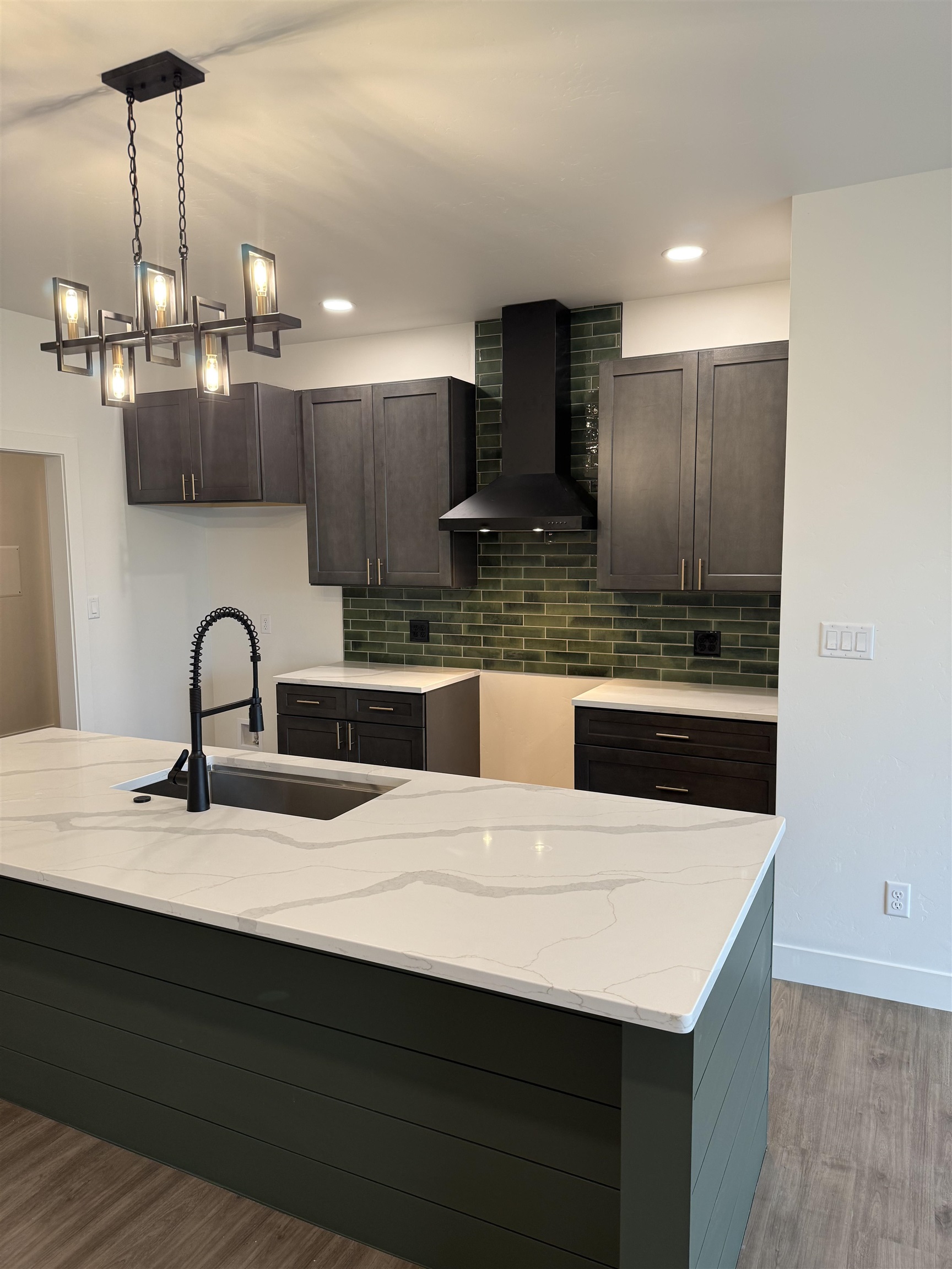 214 Limberpine Circle Parachute, CO 81635 - Photo 5 of 24 a kitchen with kitchen island a sink and wooden cabinets