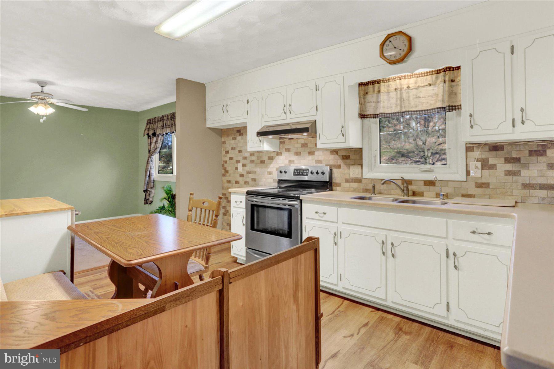 970 Cranes Gap Road Carlisle, PA 17013 - Photo 14 of 48 a kitchen with stainless steel appliances a stove a sink a microwave a refrigerator and cabinets