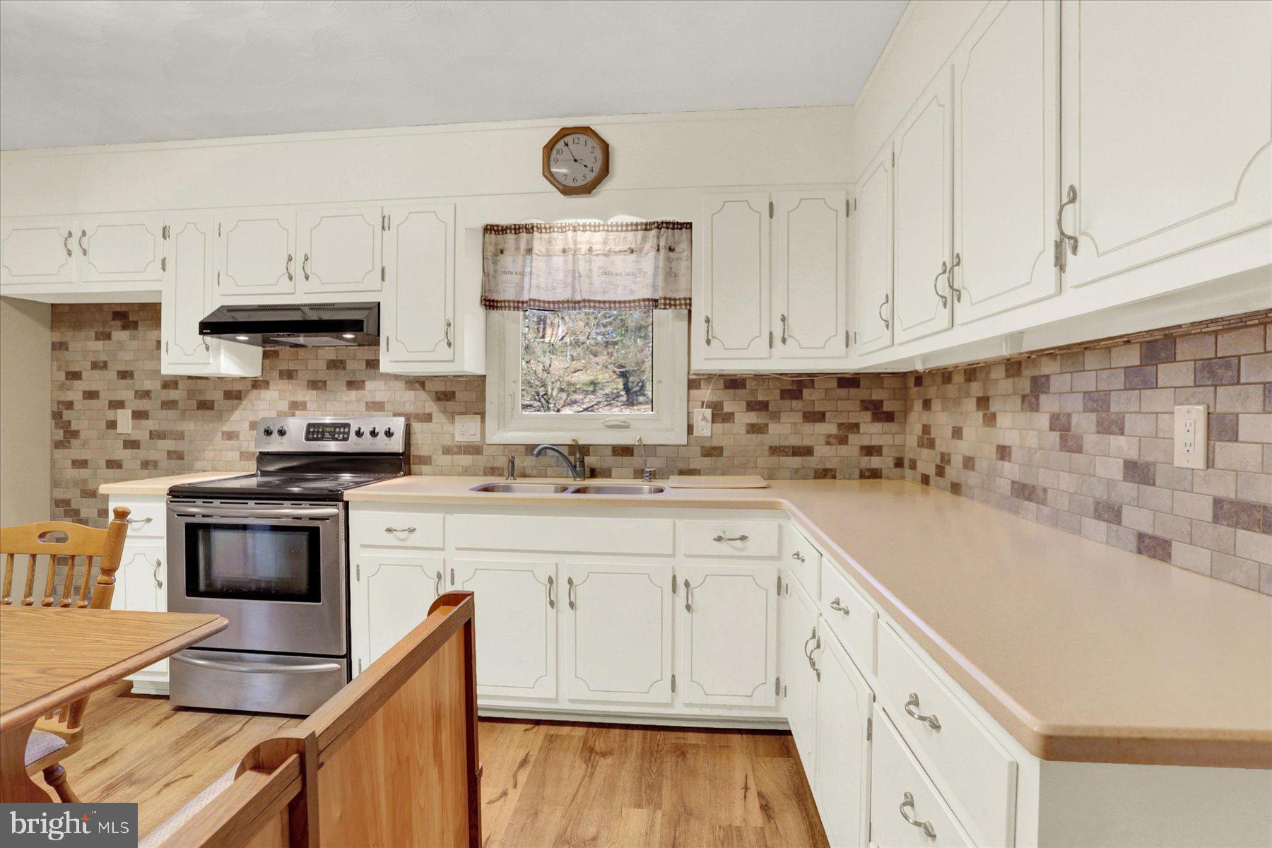 970 Cranes Gap Road Carlisle, PA 17013 - Photo 15 of 48 a kitchen with granite countertop white cabinets and white appliances