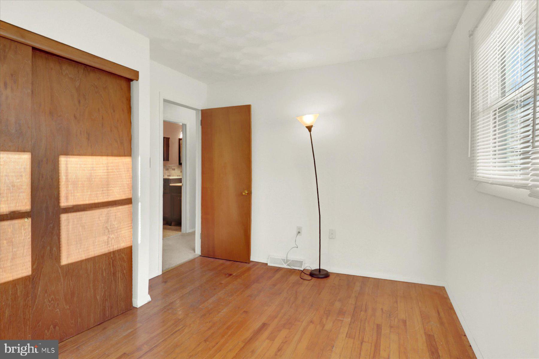 970 Cranes Gap Road Carlisle, PA 17013 - Photo 23 of 48 a view of an empty room with wooden floor and a window