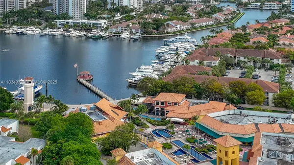 an aerial view of residential houses with outdoor space and lake view