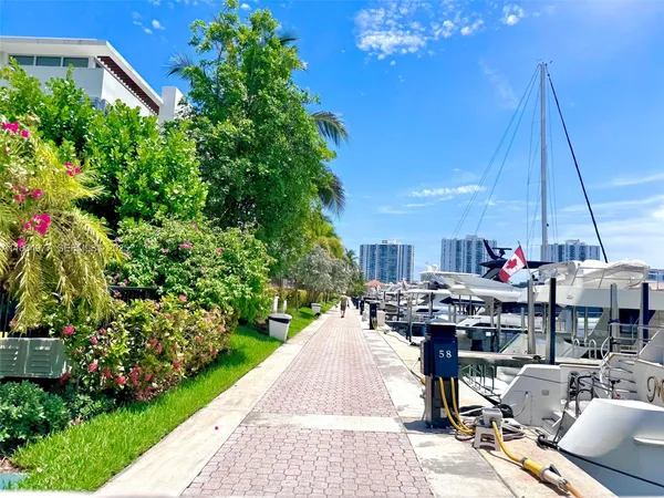 a view of a patio with table and chairs potted plants
