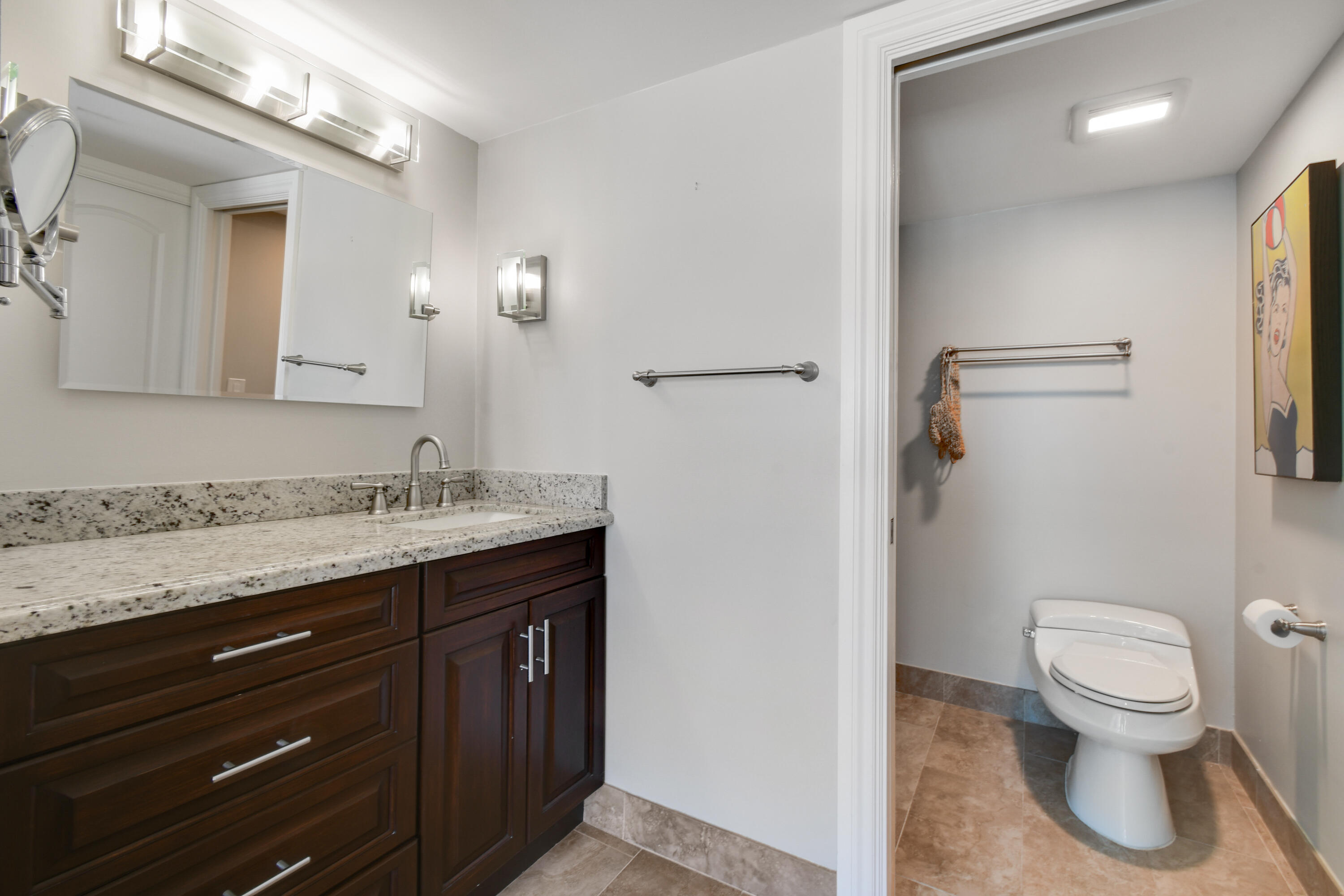 2401 Marina Isle Way, Unit 503 Jupiter, FL 33477 - Photo 21 of 46 a bathroom with a granite countertop sink toilet and shower