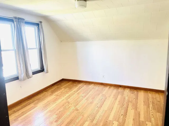 a bathroom with a sink toilet and window