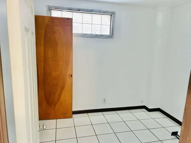 a view of a kitchen with a sink and a refrigerator