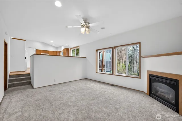 a view of empty room with window and fireplace