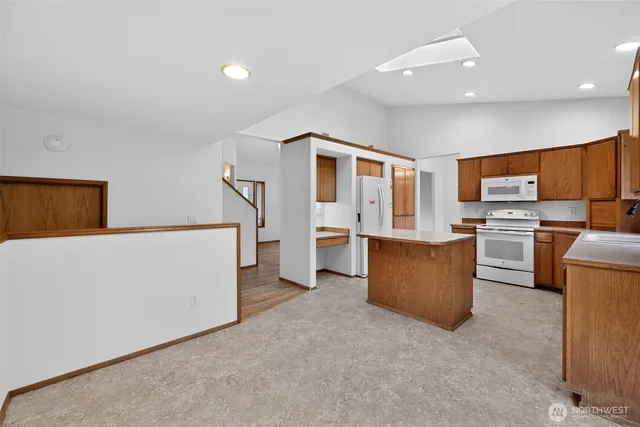 a living room with furniture and kitchen view