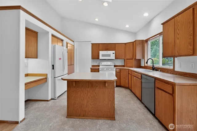 a kitchen with stainless steel appliances a sink stove and cabinets