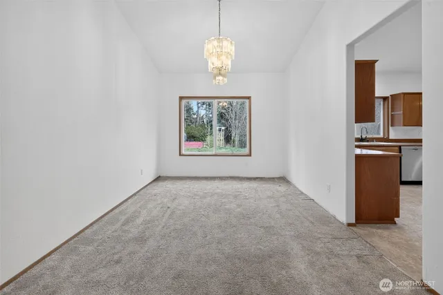 an empty room with windows and cabinet
