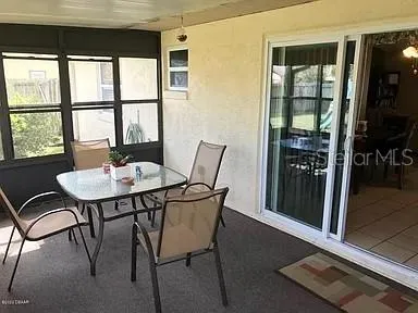 a view of a dining room with furniture window and outside view