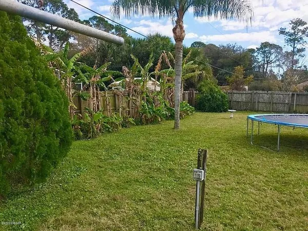 a backyard of a house with table and chairs
