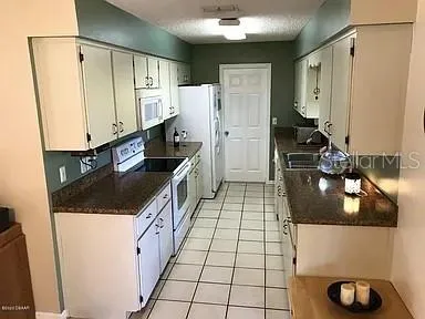 a kitchen with a sink and a refrigerator