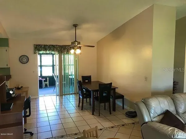 a dining room with furniture and chandelier