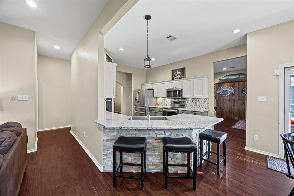 112 Springfield Lane Red Oak, TX 75165 - Photo 8 of 40 a kitchen with stainless steel appliances granite countertop a dining table chairs stove refrigerator and cabinets