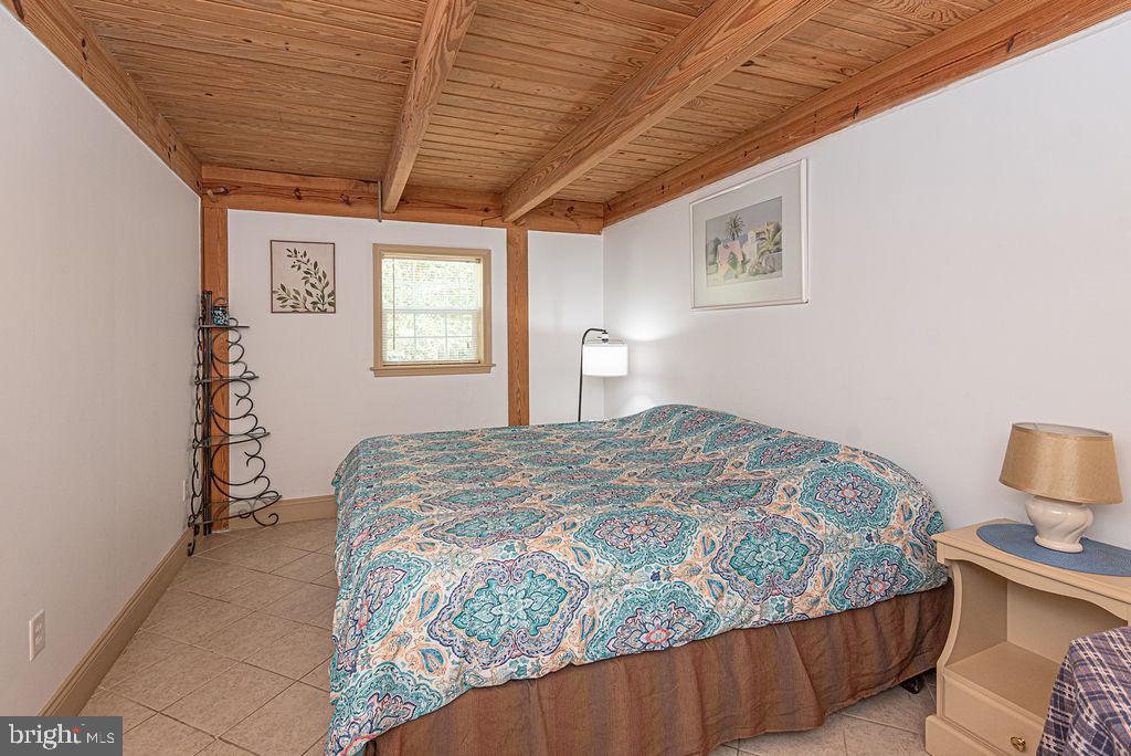 36107 Camp Barnes Road Frankford, DE 19945 - Photo 22 of 83 a bedroom with a bed and a chandelier