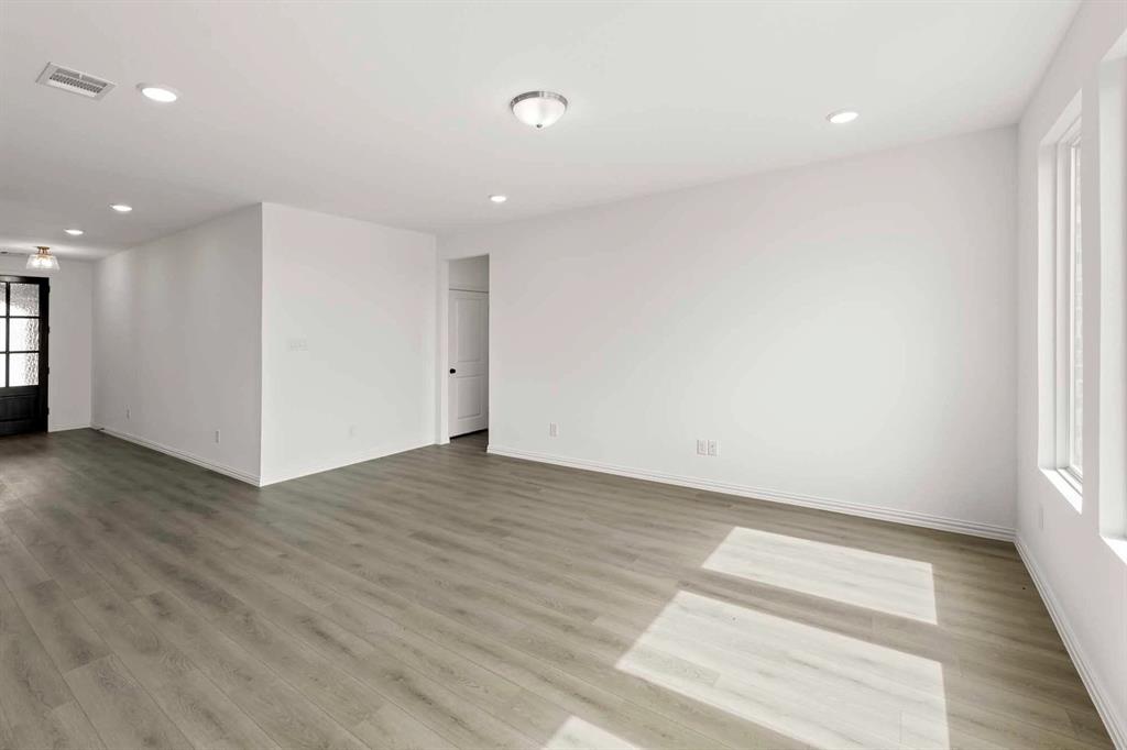 1304 Abbott Crk Road Celina, TX 75009 - Photo 11 of 29 an empty room with wooden floor and windows