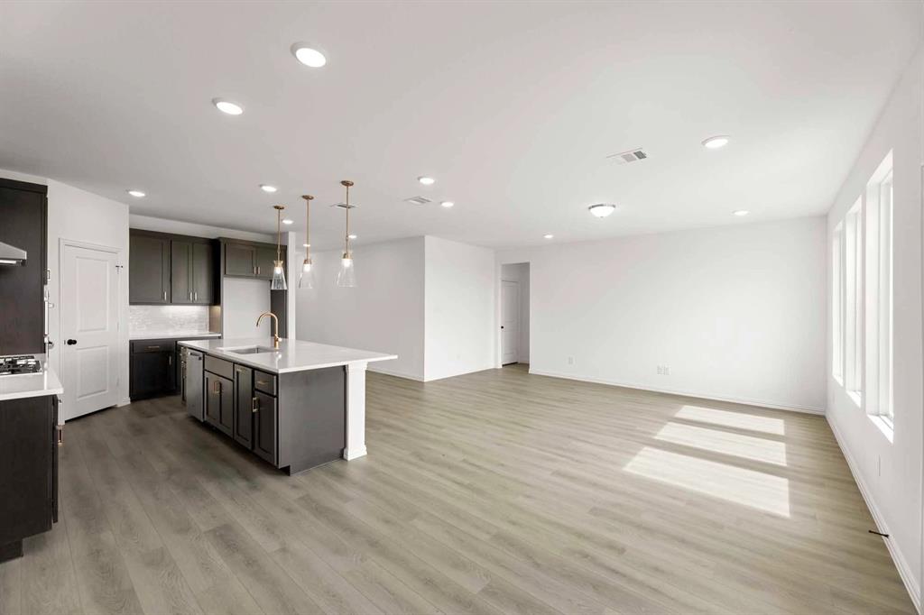 1304 Abbott Crk Road Celina, TX 75009 - Photo 16 of 29 a large kitchen with a large counter top and stainless steel appliances