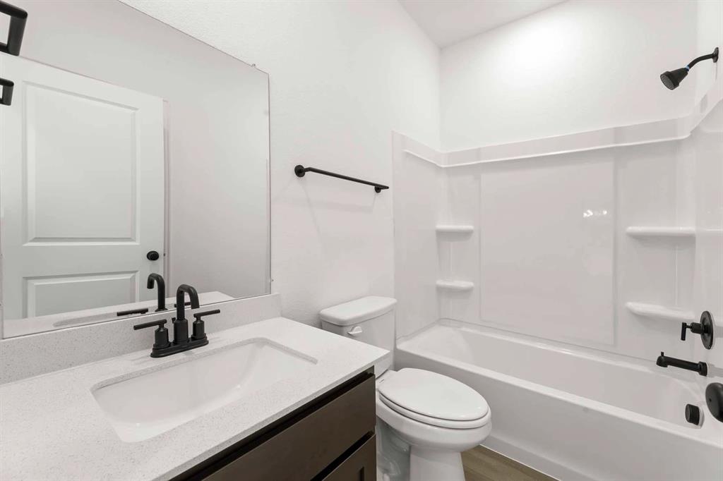 1304 Abbott Crk Road Celina, TX 75009 - Photo 18 of 29 a bathroom with a sink a toilet and a bathtub