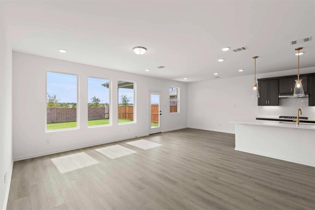 1304 Abbott Crk Road Celina, TX 75009 - Photo 10 of 29 a view of an empty room with a window and wooden floor