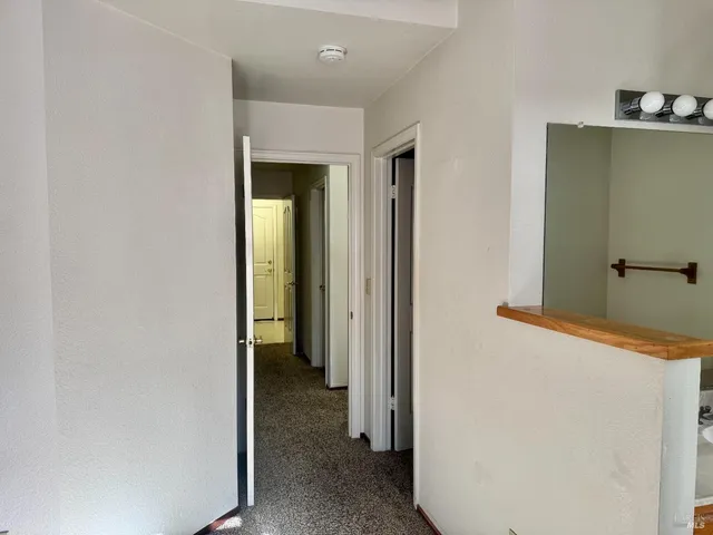 a view of hallway with bathroom