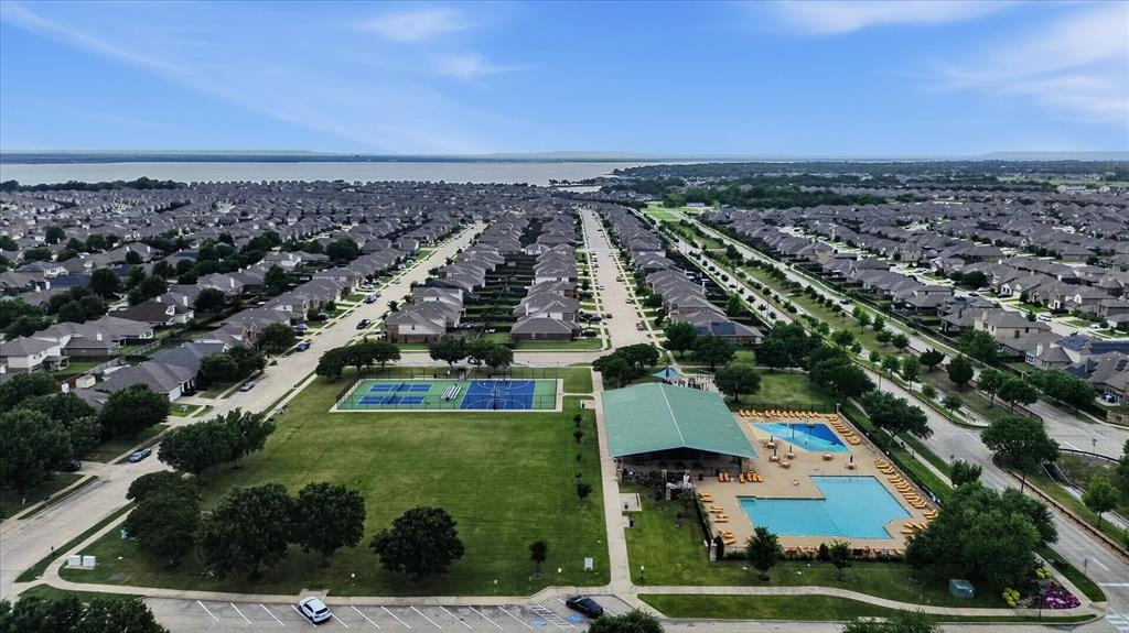 2428 Rosharon Drive Forney, TX 75126 - Photo 30 of 40 Aerial view showcasing a master-planned community with tree-lined streets, manicured green spaces, and resort-style amenities including multiple swimming pools and recreational facilities