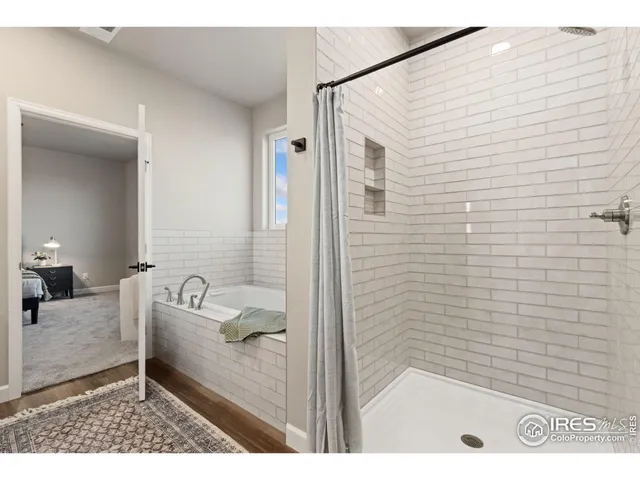 a bathroom with a tub a sink and a shower