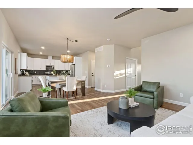 a living room with furniture and kitchen view