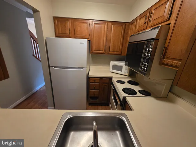 a kitchen with a refrigerator and a sink