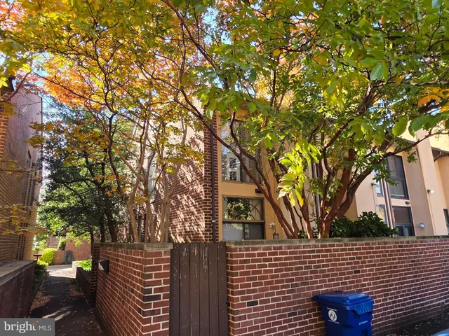 a brick building with a trees in front of it