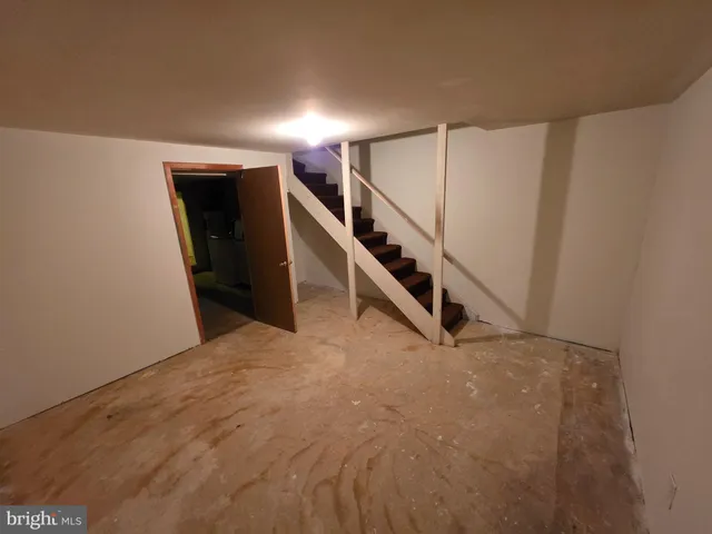 a bed sitting in a room next to a window