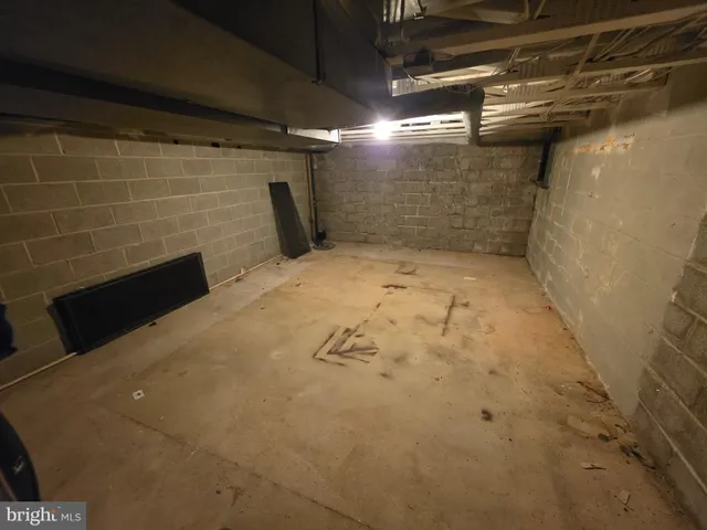 a view of a tennis ground with furniture