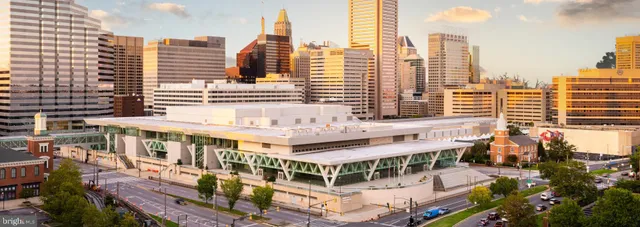a view of swimming pool with outdoor seating and city view