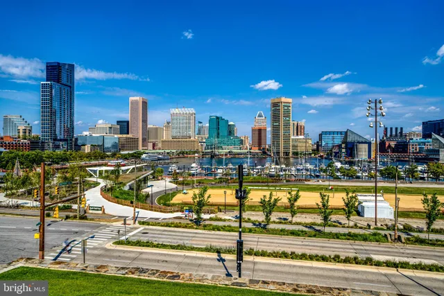 a view of a swimming pool with a bench and lawn chairs