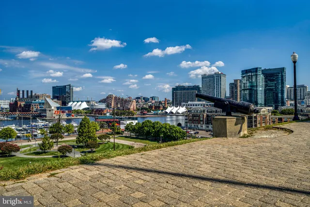 a living room with lots of white furniture and a fountain