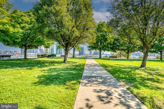 a view of yard with swimming pool and seating space