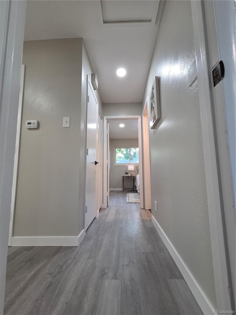 1250 South Monaco Parkway, Unit 17 Denver, CO 80224 - Photo 13 of 29 a view of hallway with wooden floor