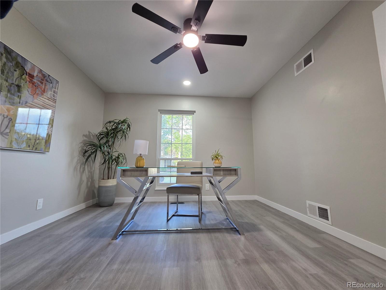 1250 South Monaco Parkway, Unit 17 Denver, CO 80224 - Photo 19 of 29 a workspace with furniture a potted plant and wooden floor